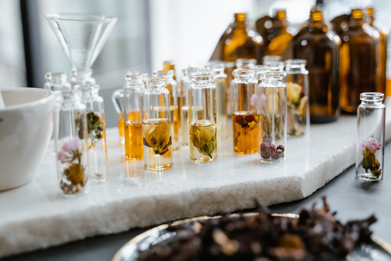 Small glass vials featuring perfume ingredients and potential fragrance allergens or sensitizers.