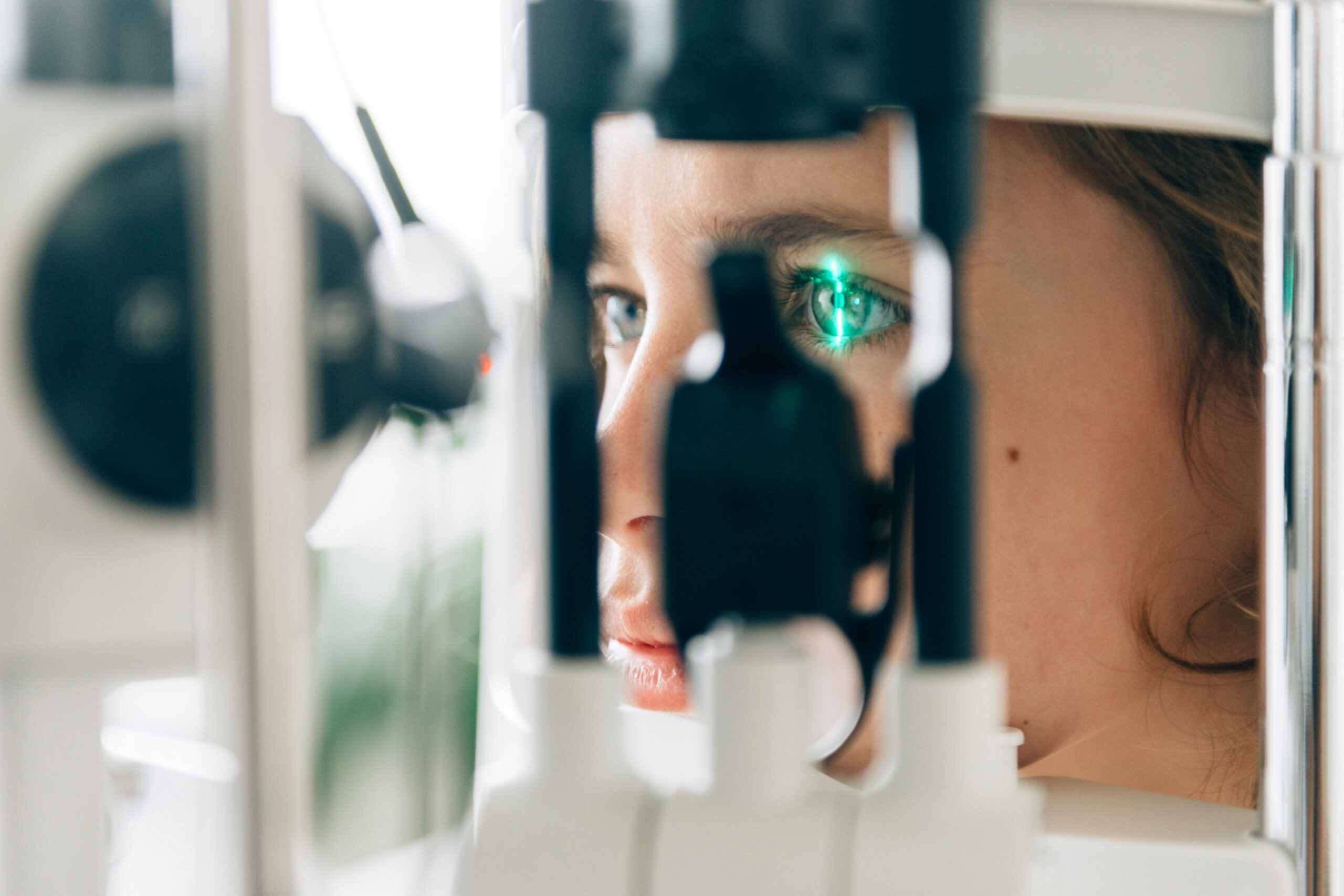 A woman uses an eye care device to check her vision.